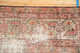 Distressed Mahal runner detail showing foundation, worn motifs, and pale red with ivory hues.