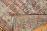Distressed vintage Mahal rug with worn pile revealing foundation and muted hues.