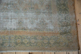 Vintage Distressed Agra carpet with even pile wear, exposed foundation, and faded gold and blue hues.