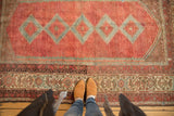 Distressed Malayer rug with low pile, featuring intricate multi-color border and cranberry field.