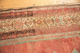 Bold ivory, powder blue, and chocolate brown border detail on a distressed Malayer rug.