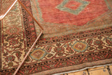 Distressed Malayer rug corner with traditional botanical borders in dusty cranberry, ivory, and powder blue.