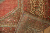 Distressed vintage Malayer rug corner showing low pile and intricately hand-knotted back.