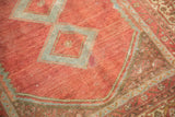Low pile dusty cranberry red field, faint foundation, powder blue medallion.