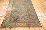 Fragmented Malayer rug showing a distressed blue-green field with red paisley boteh and geometric border.