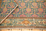 Fragmented Malayer rug lower border showing distressed blue field, gold patterns, and fringe.