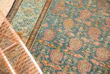 Distressed Malayer rug showcasing faded raspberry boteh and intricate vinery motifs.