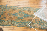 Distressed vintage Tabriz rug displaying powder blue medallion and European-influenced floral sprays.
