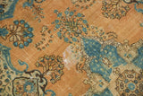 Distressed vintage Tabriz rug showcasing golden-orange, powder blue Safavid floral motifs.