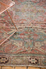 Antique Distressed Caucasian Soumac rug geometric border with muted tones and worn fringe.