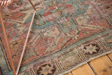 Geometric patterns and decorative distressed texture of an antique Caucasian Soumac rug, blush red and slate blue.