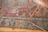 Geometric patterns and unique wear texture of an antique Caucasian Soumac rug in blush red and slate blue.