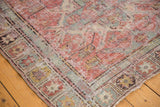 Distressed texture and geometric border detail on an antique Caucasian Soumac rug.