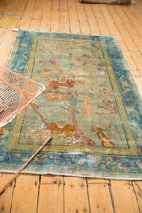 Distressed pictorial mountain motif and cloudband border on a Chinese Peking rug.