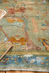 Distressed antique Peking rug pile with faded seafoam green, pictorial motifs, and cloudband border.