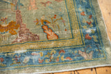 Distressed antique Peking rug corner with sky blue cloudband border and exposed foundation.