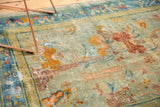 Distressed antique Peking rug, close-up showing mostly even wear, seafoam blue-green, bronze motifs.