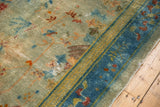 Distressed dusty gold green field, faded florals, and seafoam blue border with wear.