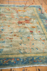 Visible foundation and distressed texture of a muted Art Deco Peking rug.