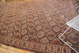 Intricate lattice motif on antique Beshir carpet, showing traditional border and even wear.