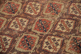 Antique Beshir carpet with terracotta, navy, brown repeating geometric panels and visible knot heads.