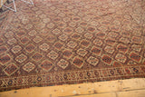 Antique Beshir carpet corner with repeating geometric panels, detailed border, and storied tones.