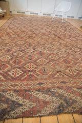 Beshir carpet's geometric panel motif and contrasting border, showing aged terracotta and navy hues.