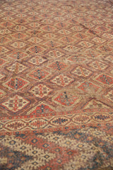 Antique Beshir carpet: intricate geometric border, repeating lattice motif, and visible pile wear.