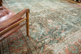 Muted teal, terracotta, and ivory tones of a distressed vintage Mahal carpet with geometric design.