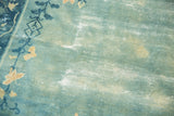 Antique distressed Peking carpet showing worn sky blue pile, exposed foundation, and faded floral vines.