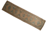 Distressed Serab runner featuring geometric medallions, intricate Herati motifs in beige and muted blue.