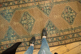 Distressed Serab runner's intricate lattice and geometric herati motifs in beige, blue, and blush.