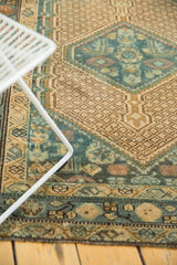 Vintage distressed Serab runner's hand-knotted pile, highlighting geometric herati motifs in muted blue and beige.