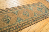 Distressed geometric border of the vintage Serab runner with dusty beige and sky blue tones.