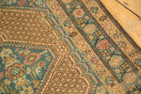 Softened geometric lattice and sky blue, blush border on a distressed vintage Serab rug.
