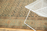 Distressed Malayer carpet detail, with worn herati motif and geometric tan and blue border.