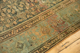 Malayer rug pile texture, showing abrash and worn herati motifs in muted blue and bronze.