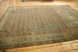 Vintage distressed Malayer carpet section, featuring worn herati motifs, teal borders, and abrashes.