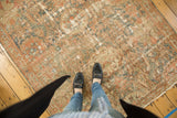 Distressed vintage Malayer rug with textural wear and faded charcoal teal, terra cotta, ivory colors.