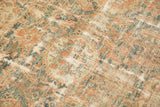 Faded roundel medallions and floral cross-sections on a distressed vintage Malayer rug.