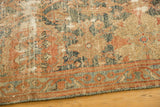 Distressed Malayer rug, showcasing worn texture and floral vinery in dusty teal and terracotta.