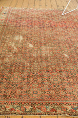 Fragmented Hamadan rug's allover herati motif, classic rainbow border, and localized foundation wear.