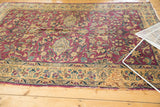 Vintage Lilihan carpet lower border with expressive floral vinery, light edge tatter, and a storied repair.