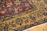 Close-up of vintage Lilihan carpet: expressive purple floral vinery on golden ground.