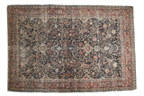 Antique Persian Tabriz rug, intricate allover floral arabesques on dark navy with terracotta borders.