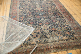 Intricate navy field of sprawling arabesques and floral palmettes on an antique Tabriz rug segment.