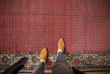 Vintage Malayer carpet with rich brick red allover boteh field and its geometric Mir Serbend border.