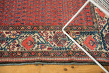 Vintage Malayer carpet corner detail: brick red boteh field and ivory Mir Serbend border.