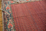 Vintage Malayer carpet with repeating dark boteh on brick red, next to ivory Mir Serbend border.