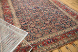 Vintage Bijar carpet's cherry red border with intricate budded blossoms and mostly secured ends.
